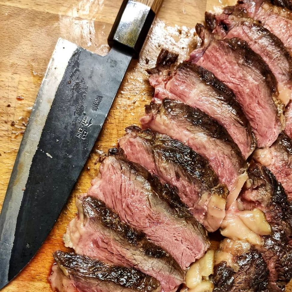 A steak sliced with a carbon steel knife