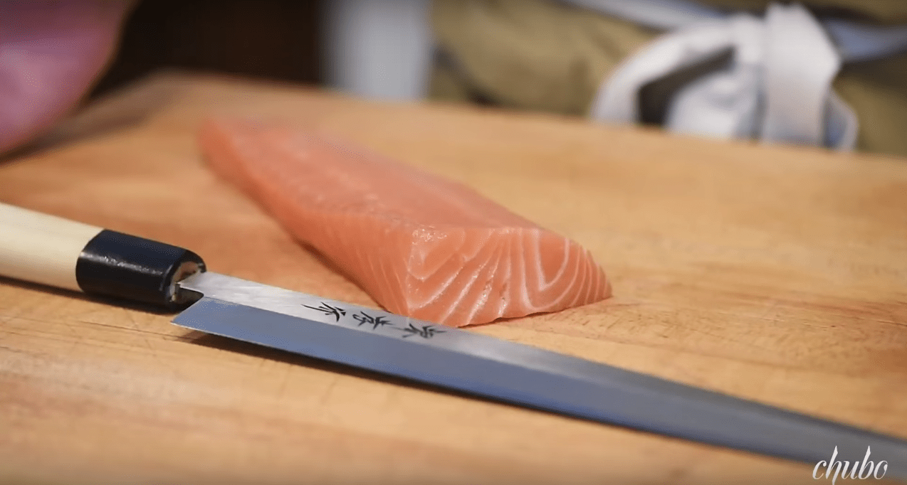 Close-up of a high-quality Japanese kitchen knife with a sharp blade and ergonomic handle.