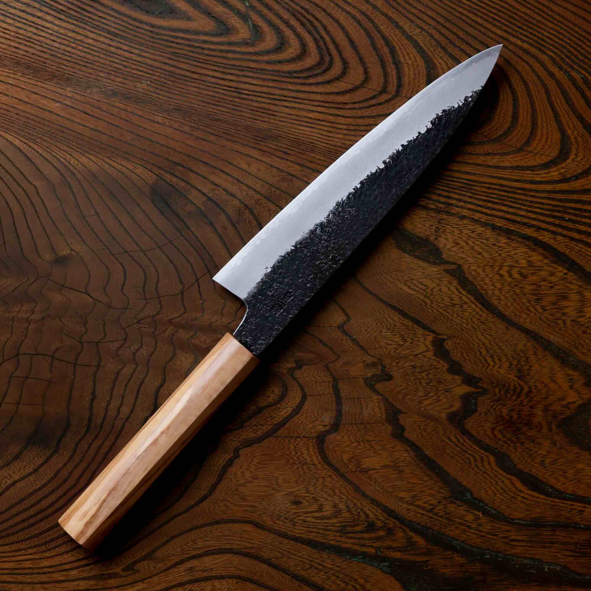 Knife with a wooden handle on a wooden surface