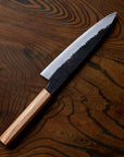 Knife with a wooden handle on a wooden surface